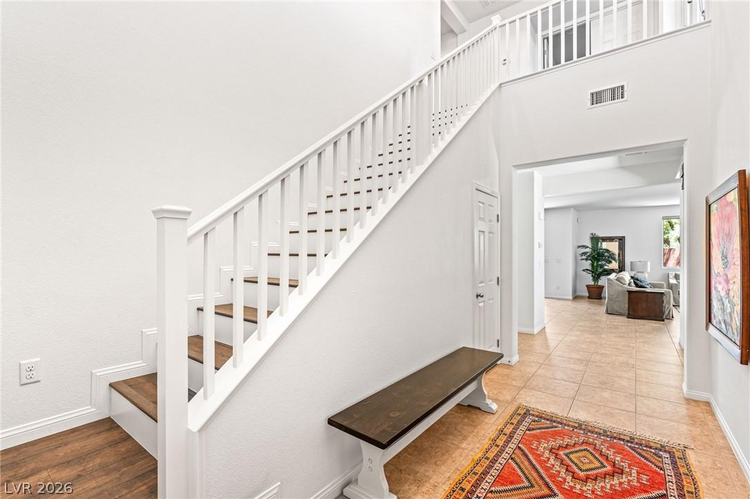 Image 3: A grand staircase with rich wooden treads ascends