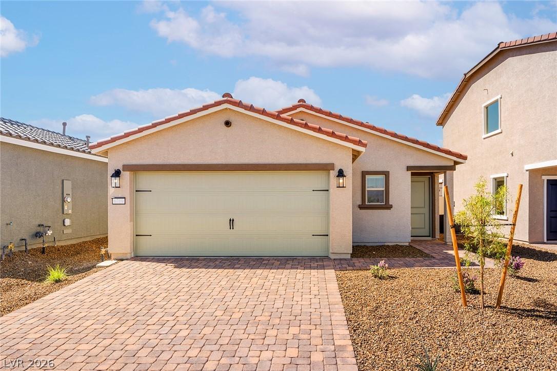Image 1: A well-maintained stucco home with a tile roof and