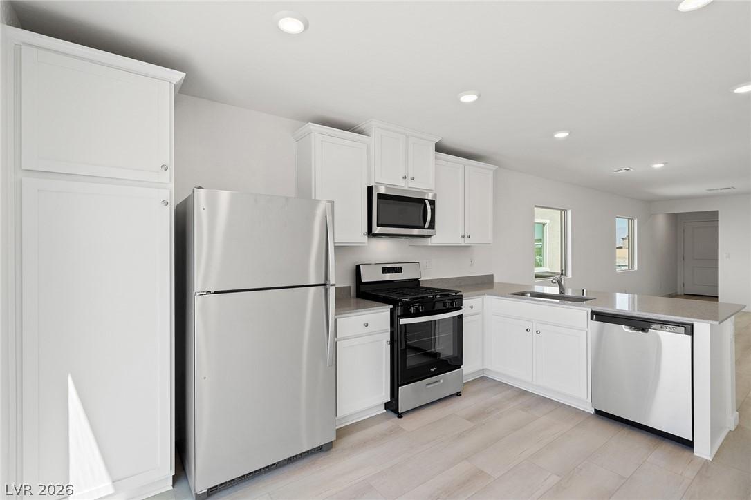 Image 4: A well-lit kitchen with sleek stainless steel appl