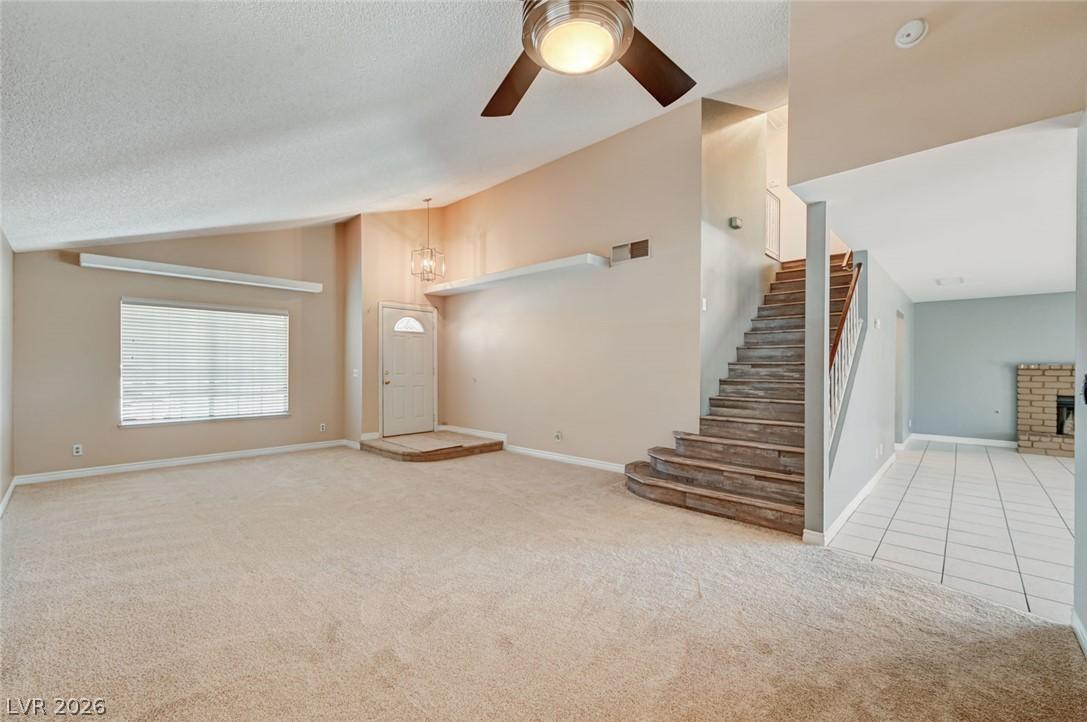 Image 4: A well-lit interior features a graceful staircase,