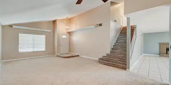 Image 4: A well-lit interior features a graceful staircase,