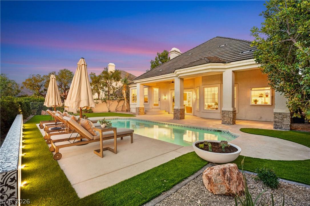 Image 3: An inviting pool area with plush lounge chairs cre