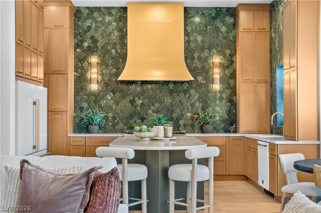Image 4: An inviting kitchen with light wood cabinetry and