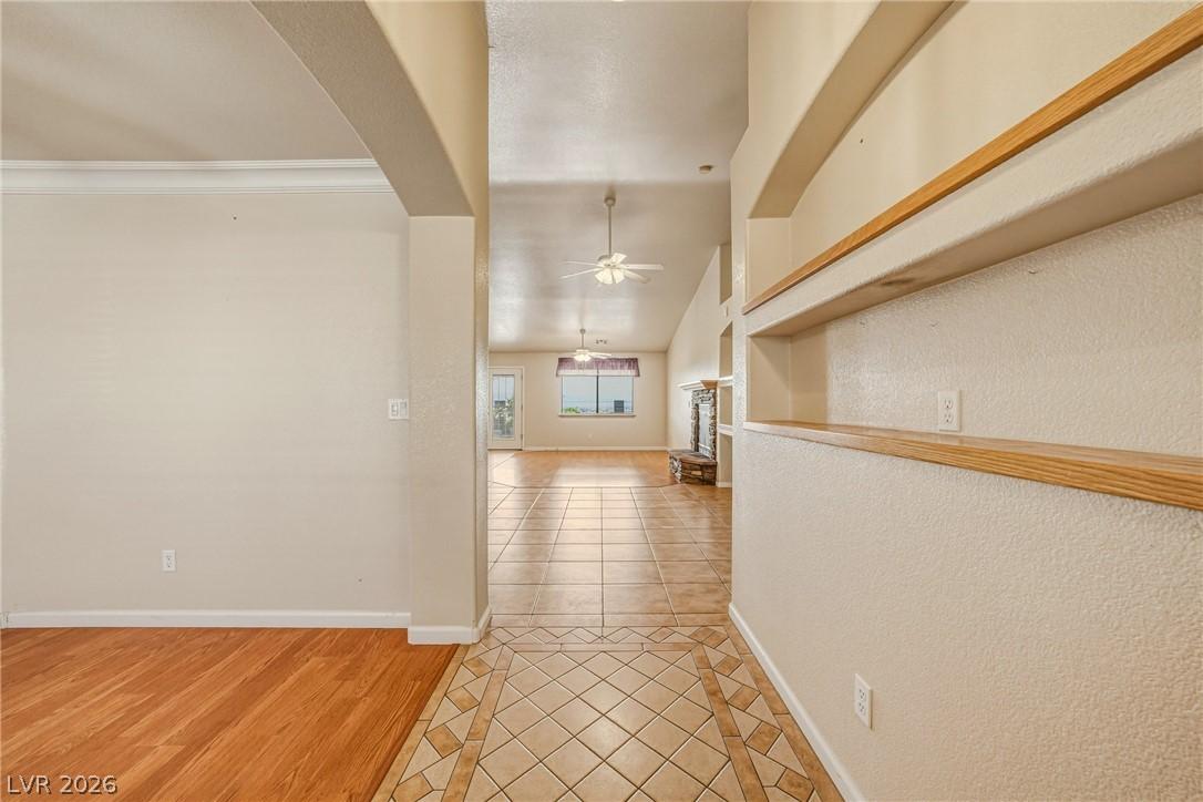 Image 2: This inviting hallway features contrasting floorin