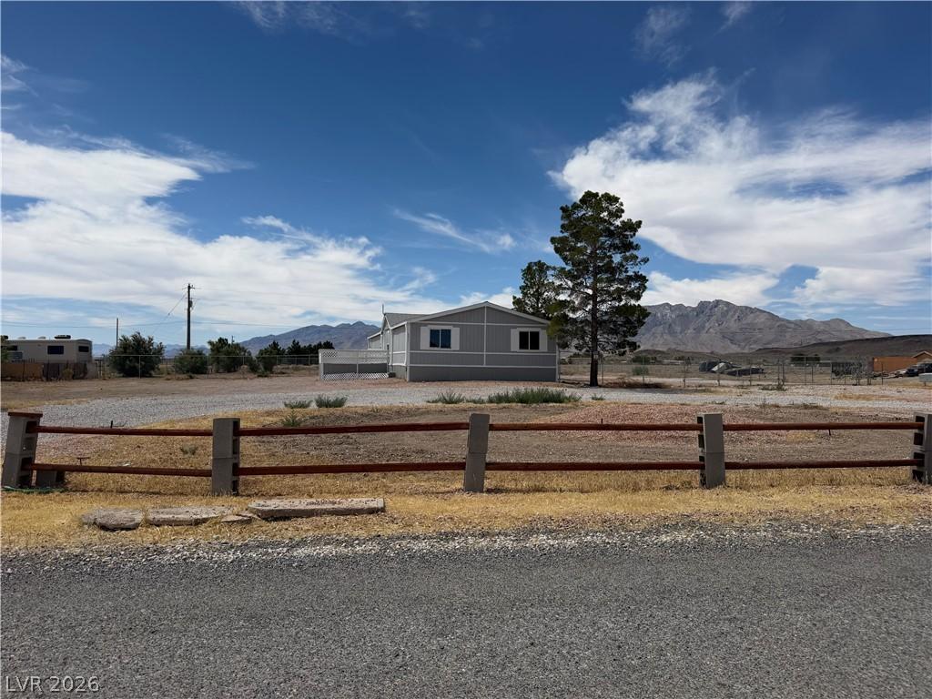 Image 2: A rural setting with mountain views surrounds this