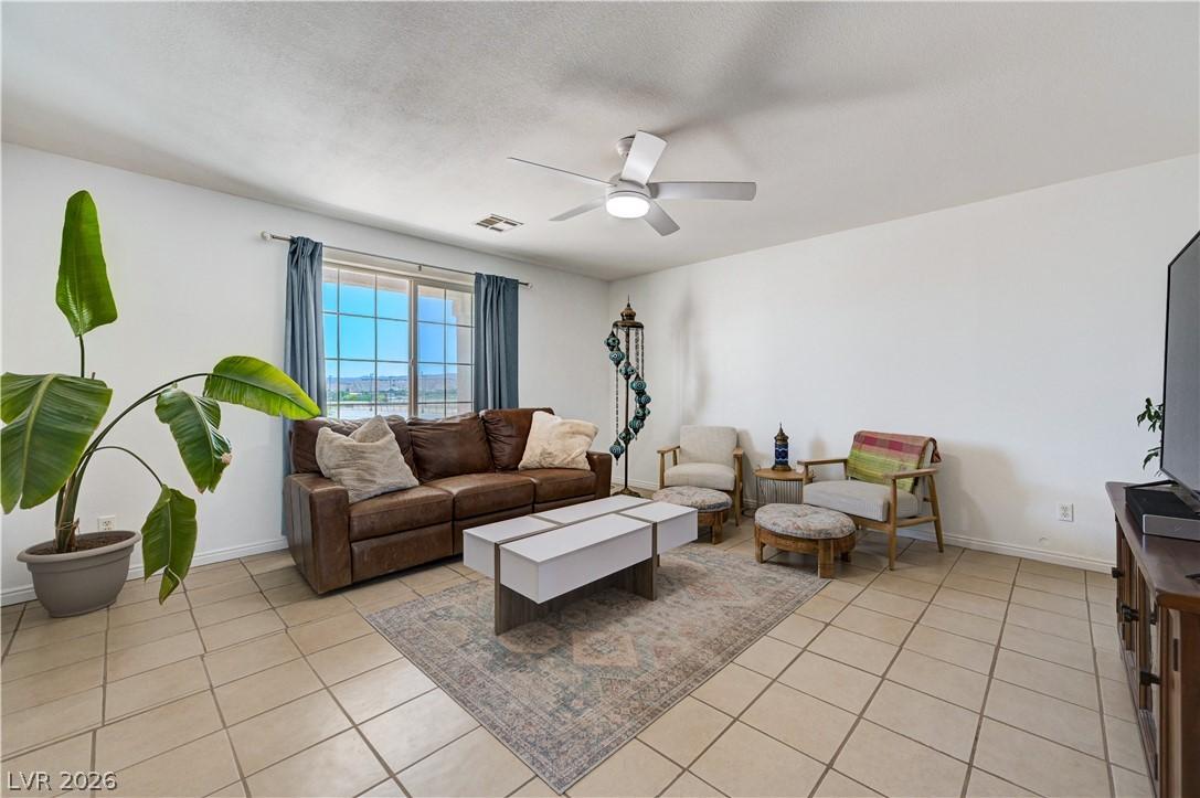 Image 2: Sun-filled living area features tile flooring, a l