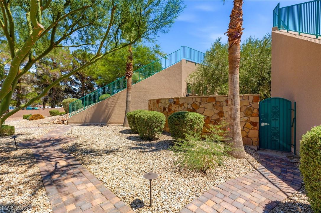 Image 3: A charming walkway leads through drought-tolerant