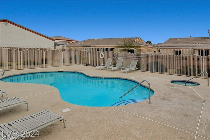 Image 2: A well-maintained community pool and spa offers re
