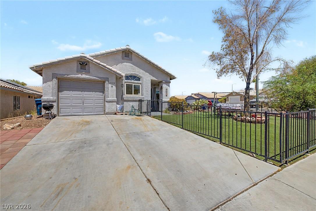 Image 2: A fenced front yard with mature landscaping enhanc