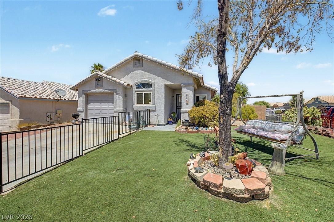 Image 3: Fenced front yard offers a charming swing beneath