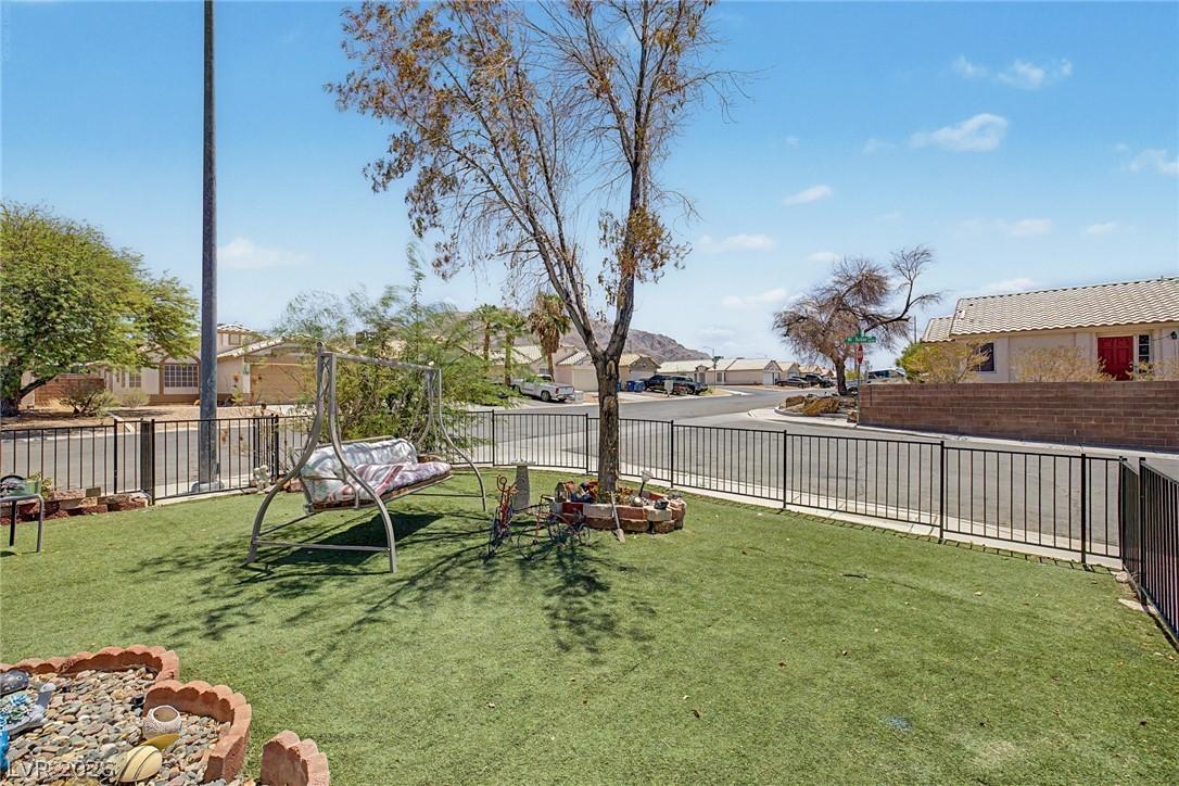 Image 4: Securely fenced yard space offers a charming swing