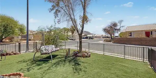Image 4: Securely fenced yard space offers a charming swing