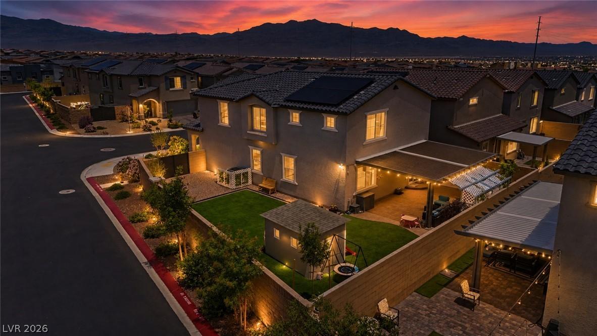 Image 1: Dusk settles over a charming neighborhood, illumin