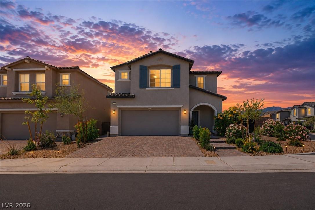 Image 2: Twilight paints a beautiful sky over this home wit
