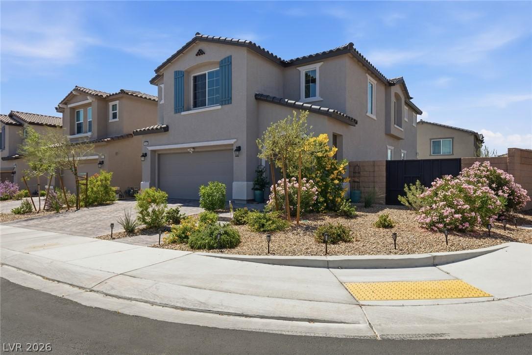 Image 4: A Mediterranean-style home with stucco exterior an