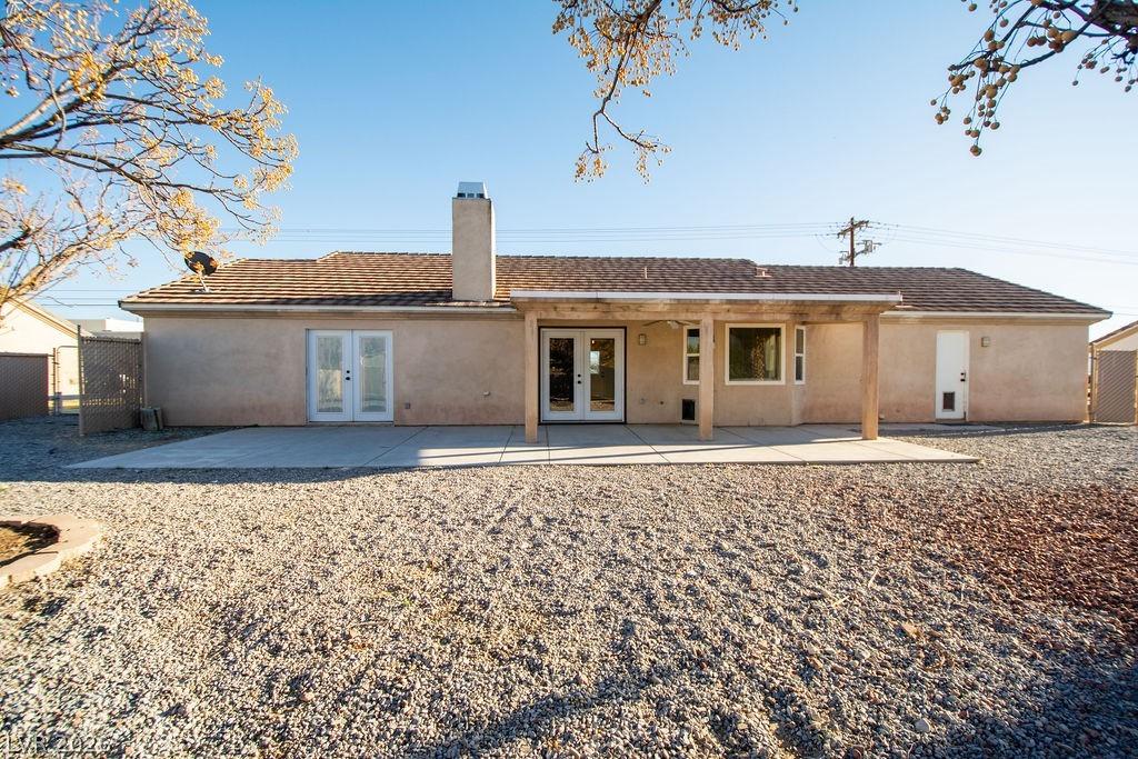 Image 1: Rear view of property featuring french doors, stuc