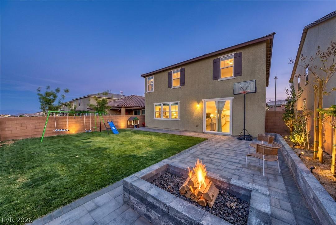 Image 2: This outdoor space offers a paved patio, lush lawn