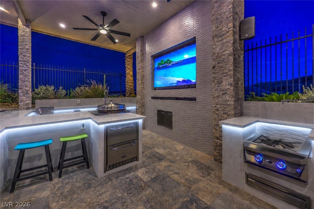 Image 2: An inviting outdoor kitchen provides the perfect s