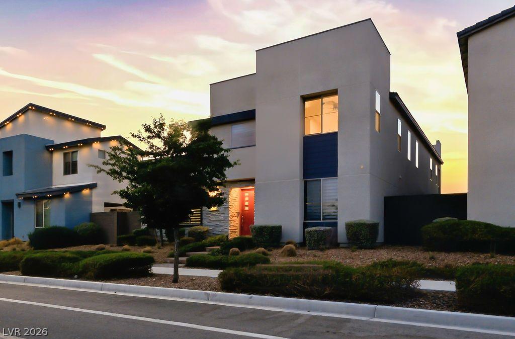 Image 3: Bold modern architecture with a striking red door