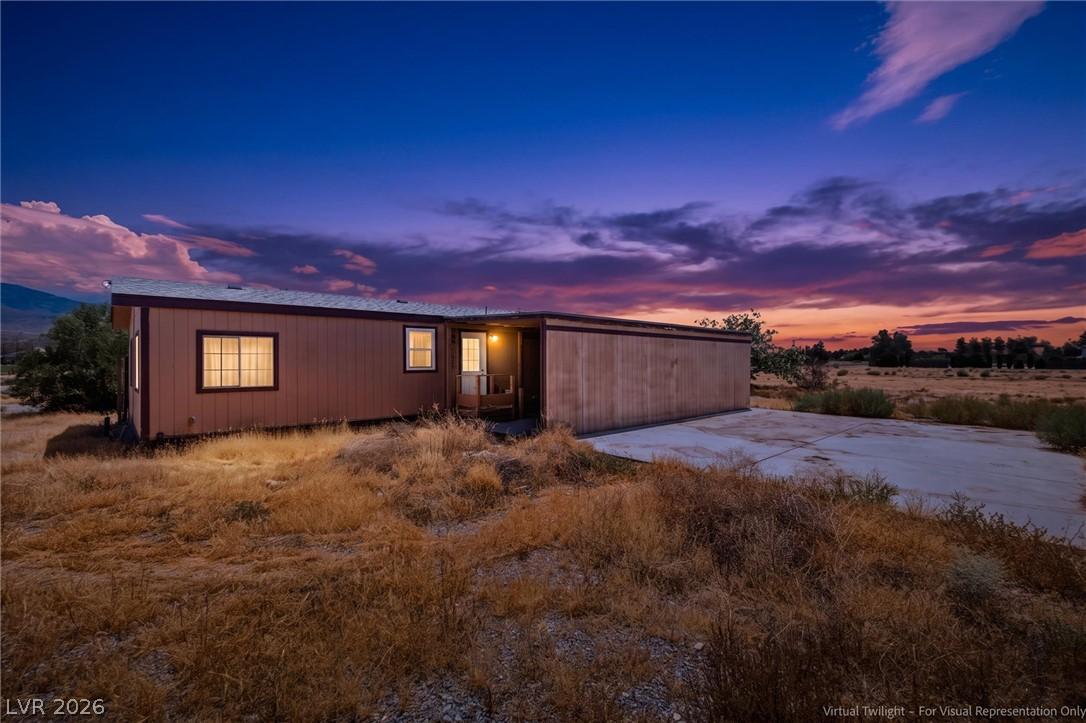 Image 2: A manufactured home sits against a vivid twilight