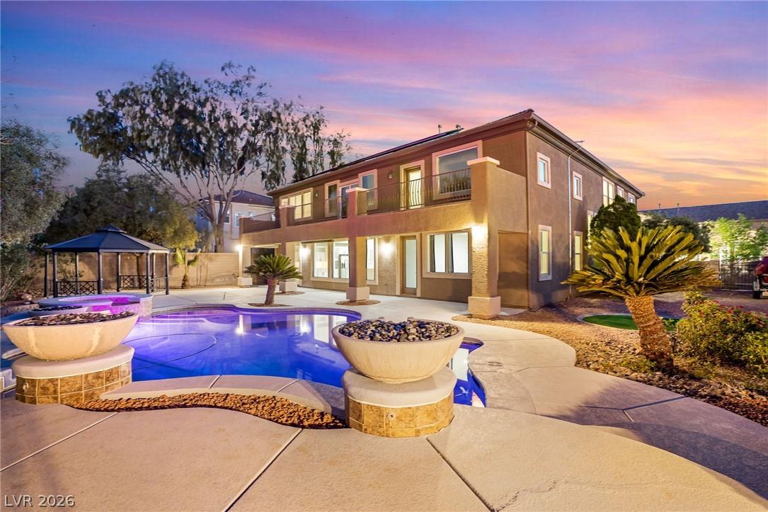 Image 1: An inviting backyard oasis offers a sparkling pool