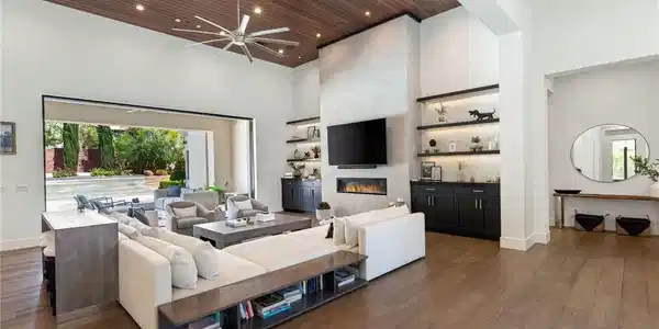 Image 4: Rich wood plank ceilings and pocketing glass doors