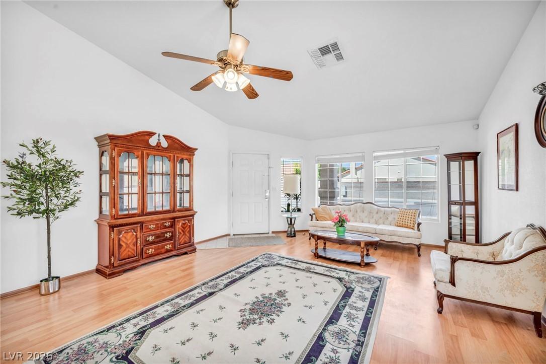 Image 3: A cheerful living area features lustrous hardwood