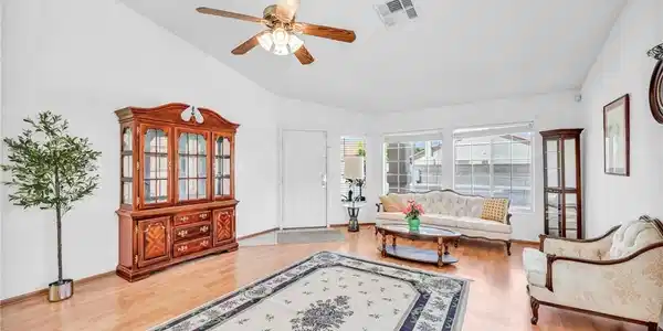 Image 3: A cheerful living area features lustrous hardwood