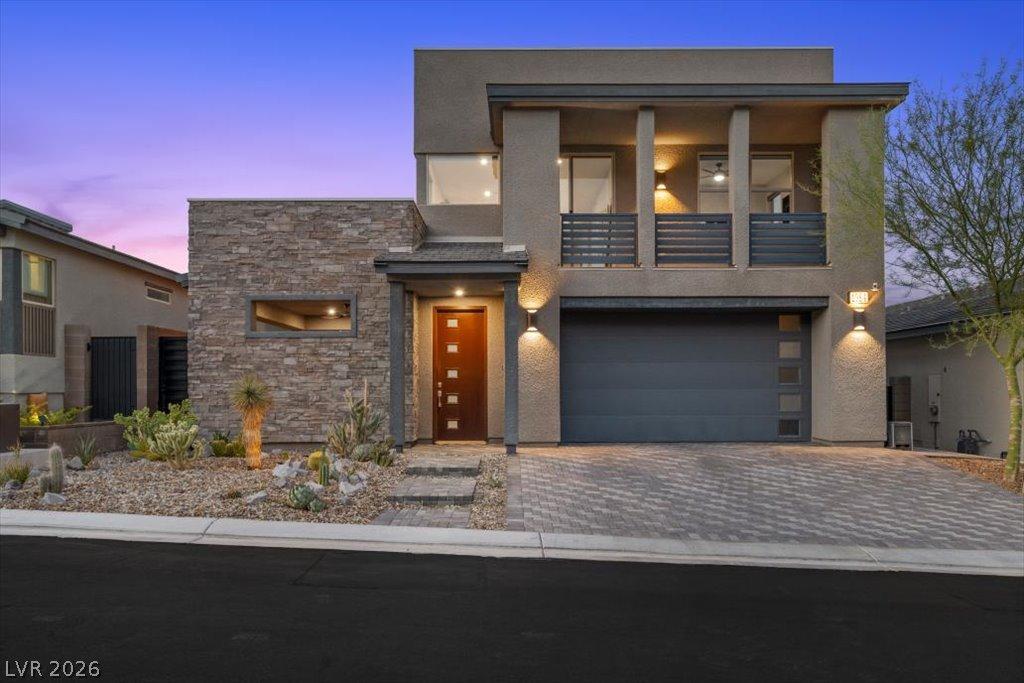 Image 1: A modern facade with stacked stone accents and a p