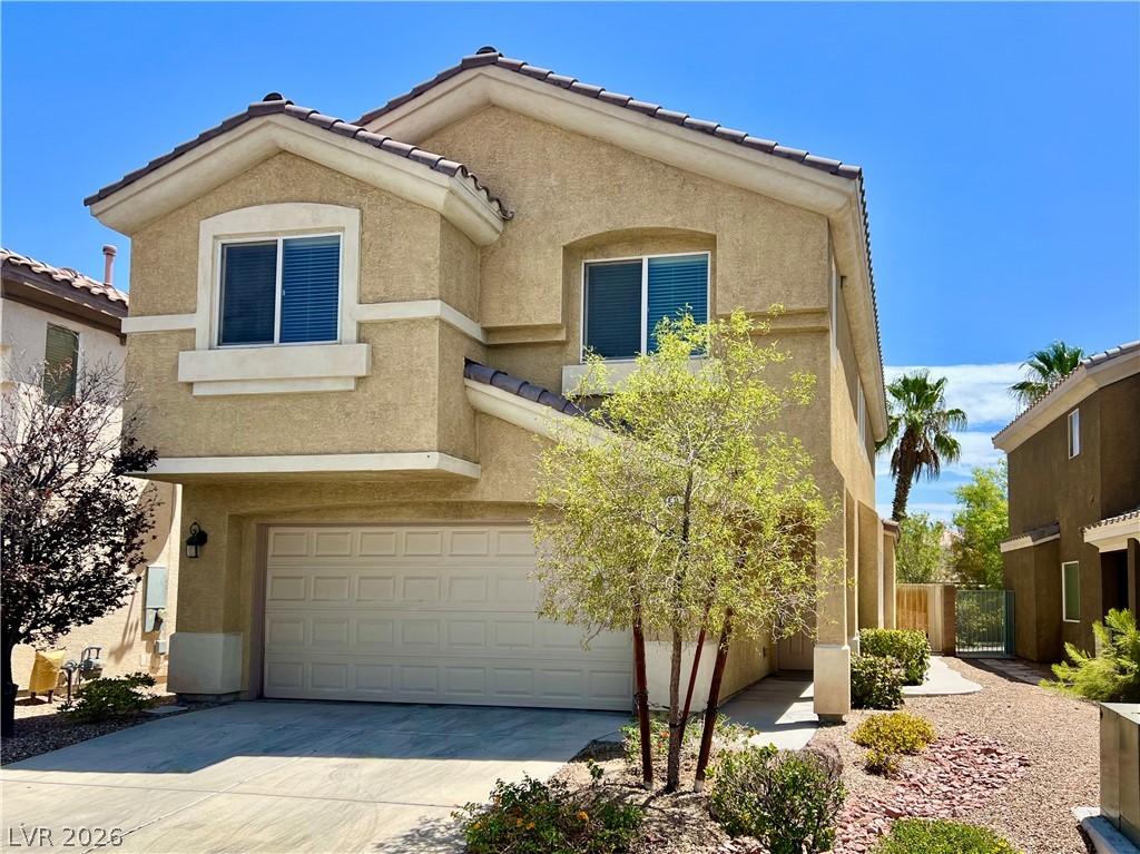 Image 2: A classic stucco facade with a two-car garage, Low