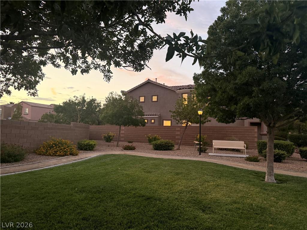 Image 2: A verdant lawn and paved pathway invite tranquil s