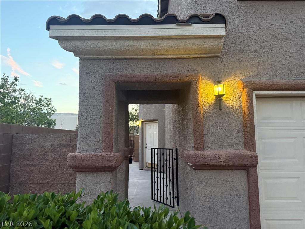 Image 4: An inviting entry archway with wrought iron gate w