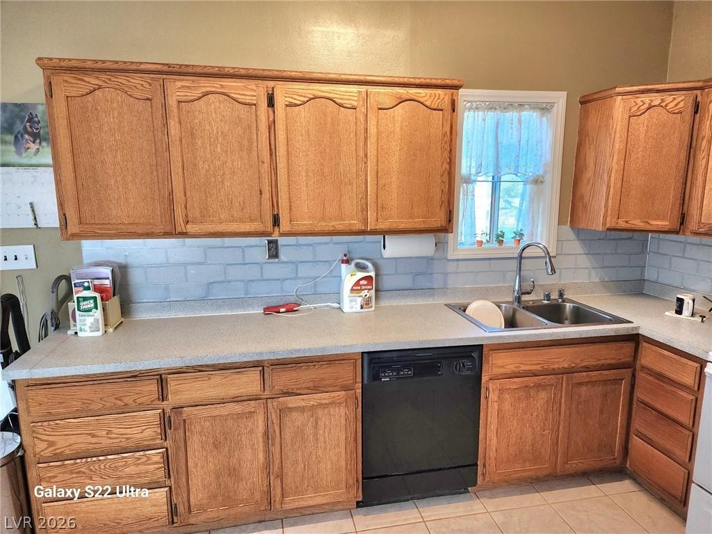 Image 3: Kitchen featuring black dishwasher, light countert