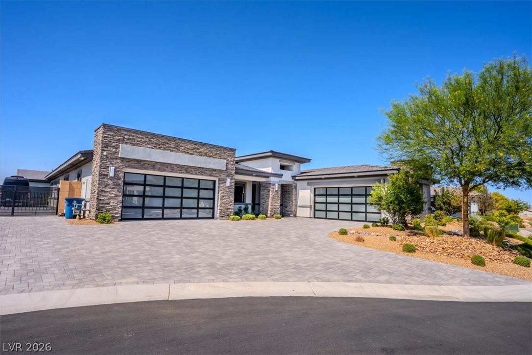 Image 2: Modern desert architecture with a textured stone f