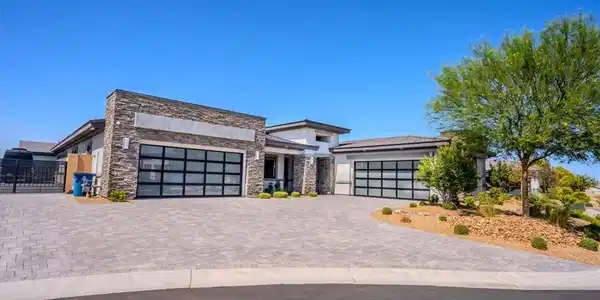 Image 2: Modern desert architecture with a textured stone f
