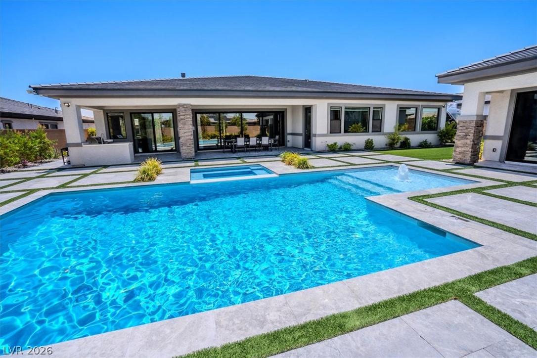 Image 3: A private backyard oasis showcases a sparkling poo