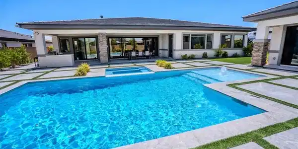 Image 3: A private backyard oasis showcases a sparkling poo