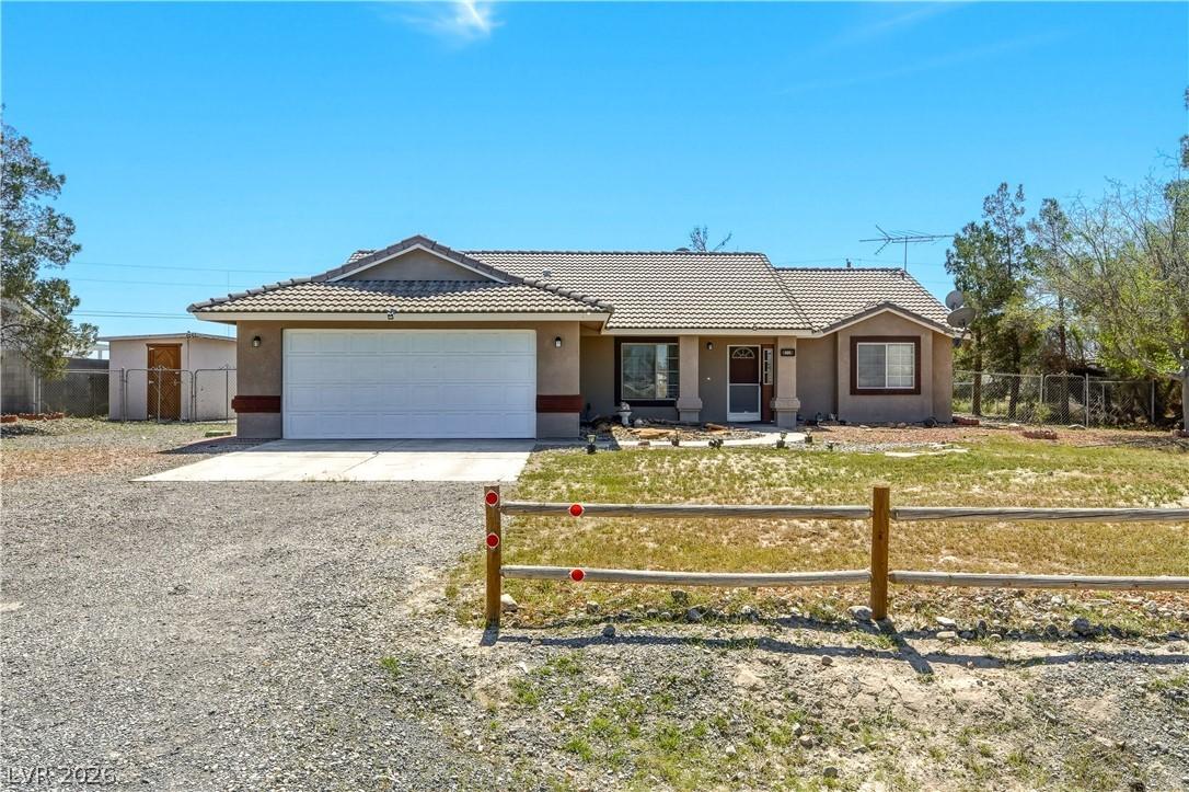 Image 2: Single story home featuring driveway, stucco sidin