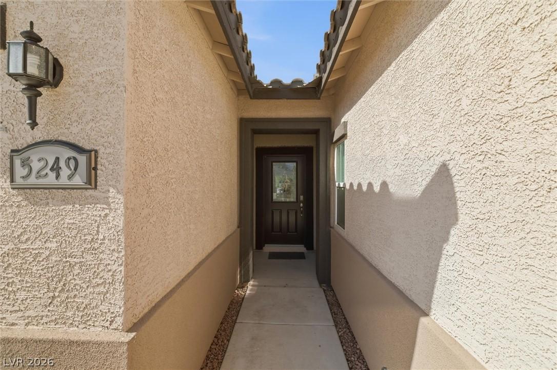 Image 3: A welcoming entryway with a dark wood door and dec