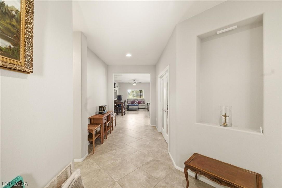 Image 4: This interior hallway features neutral-toned tile
