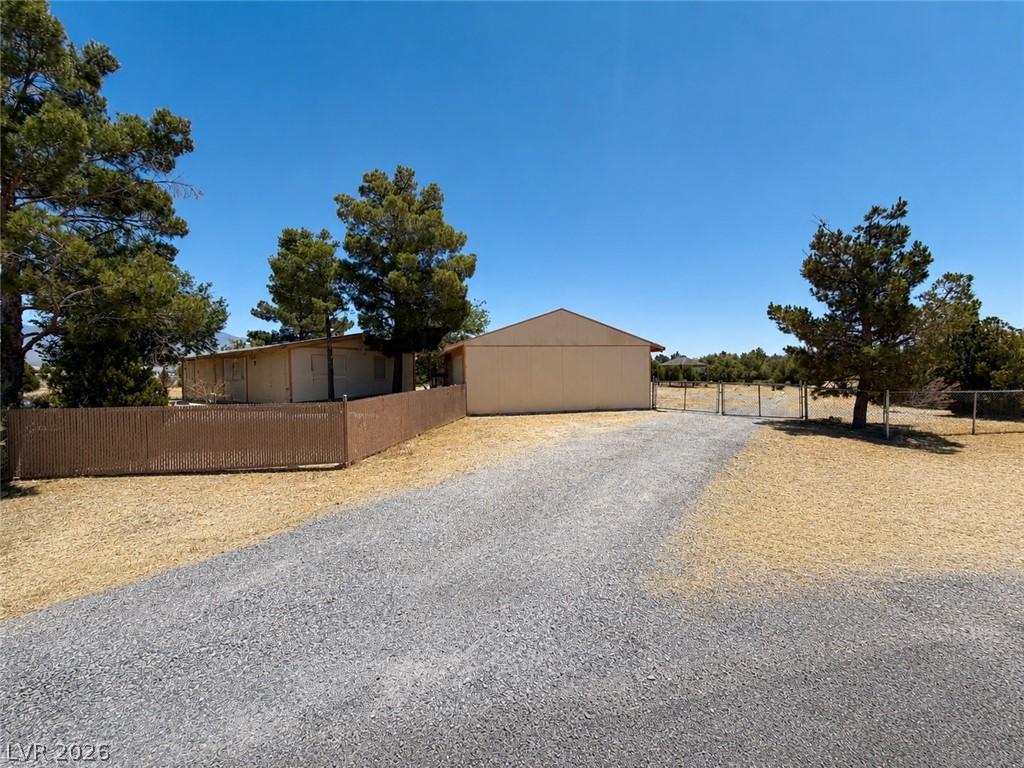Image 2: A sprawling gravel driveway leads to a secluded pr