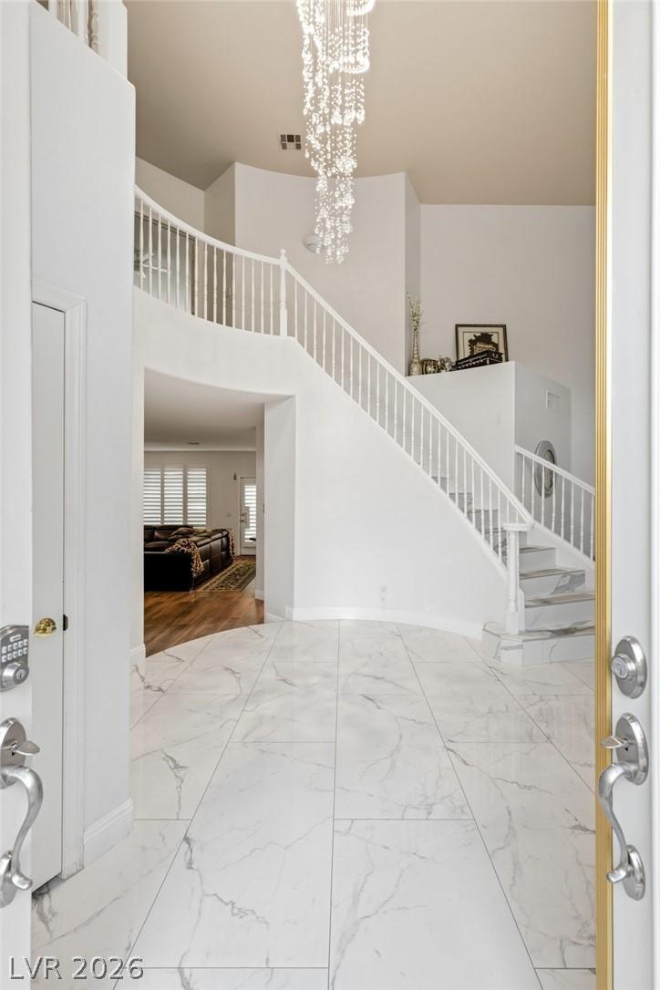 Image 3: Enter into a grand foyer featuring a sweeping stai