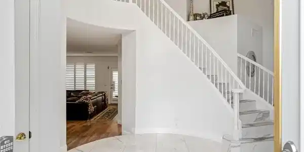 Image 3: Enter into a grand foyer featuring a sweeping stai