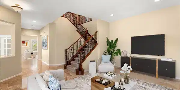 Image 3: Living room with stairway, recessed lighting, and