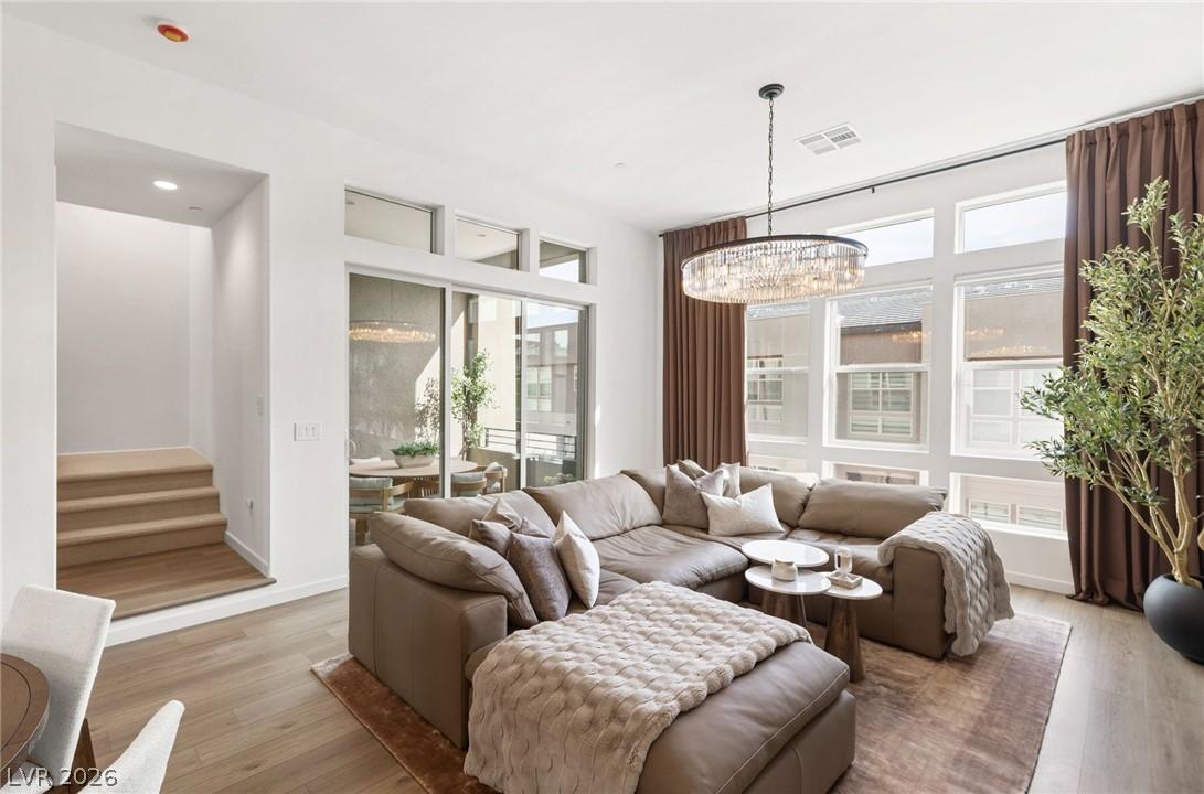 Image 4: Living area featuring wood-like finished floors an