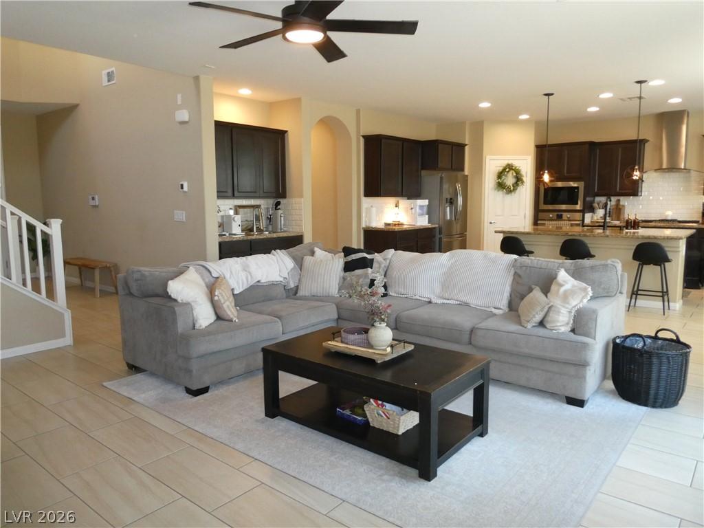 Image 4: An inviting open-concept living area flows seamles