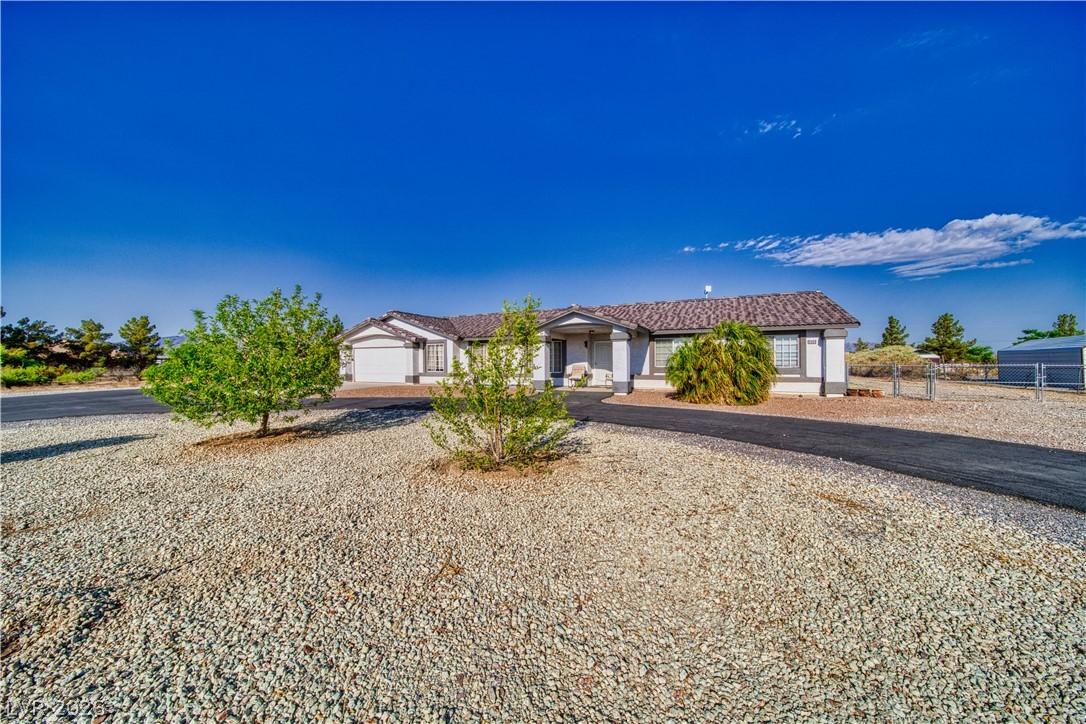 Image 2: A well-maintained single-story home with a paved d