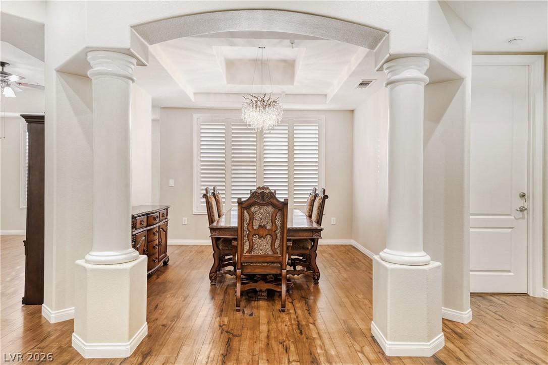 Image 3: Elegant columns frame this spacious dining area wi