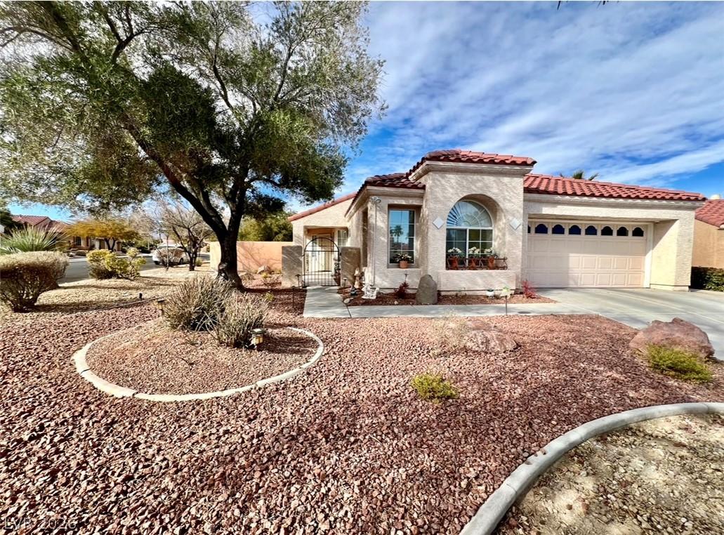 Image 2: A well-maintained stucco home with a terracotta ro