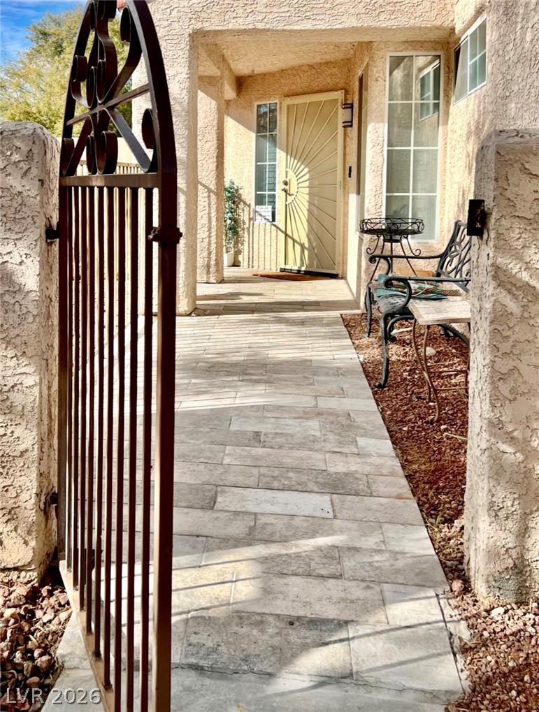 Image 3: An inviting gated walkway leads to a covered front